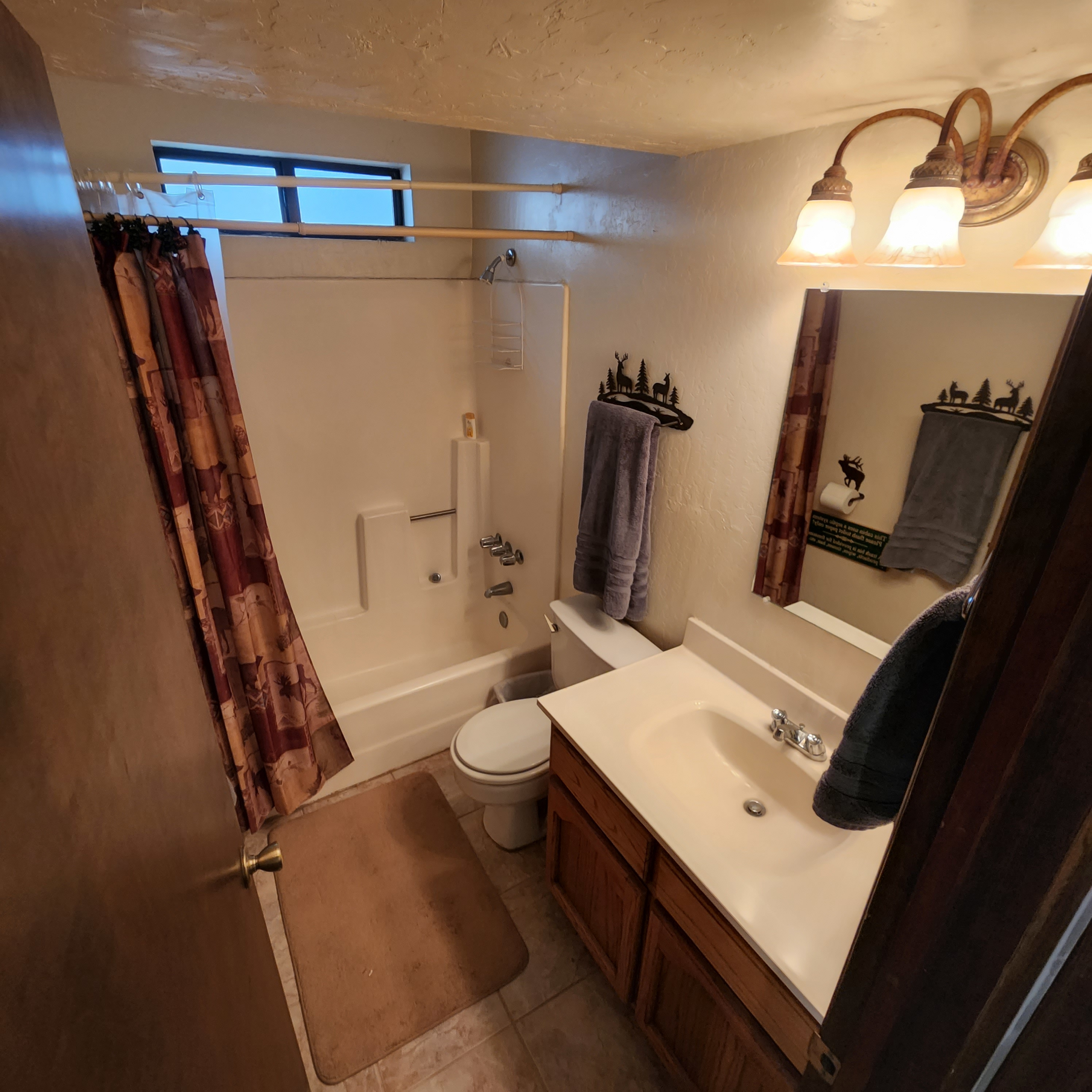 Bathroom - A fully equipped bathroom with toilet, sink and bathtub with shower.