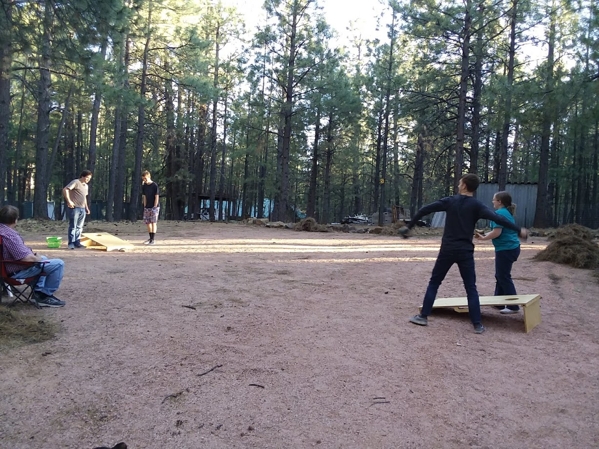 Family Cornhole - Whether your playing or just watching, the weather is perfect and the family time is awesome.