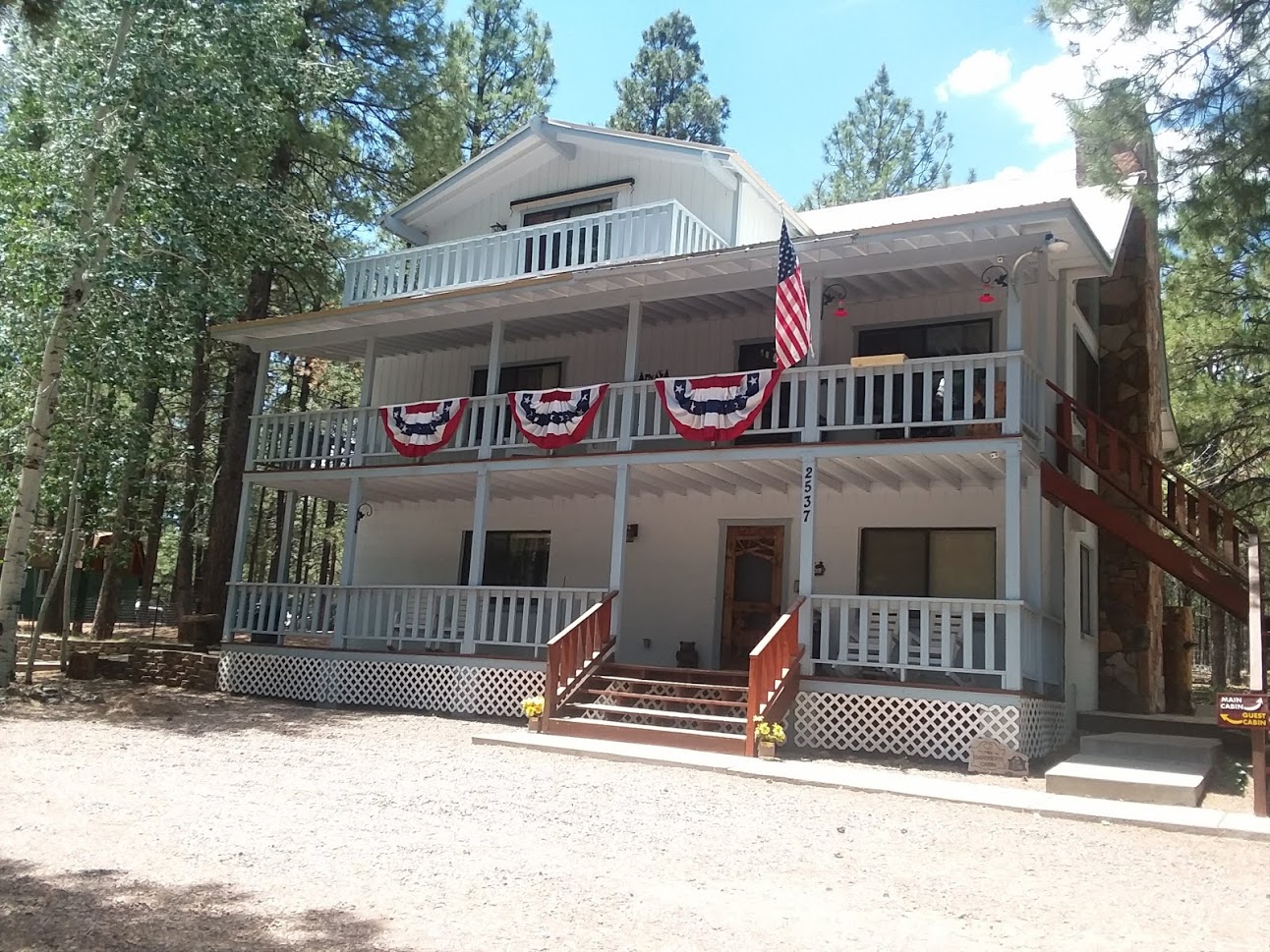 Front Cabin View - Summer usually means a patriotic display. The Forest Lakes 4th of July ATV parade is also a highlight and it goes right down the road in front of the cabin. Bring bags so the kids can carry all the candy that gets thrown to them by the ATVs.