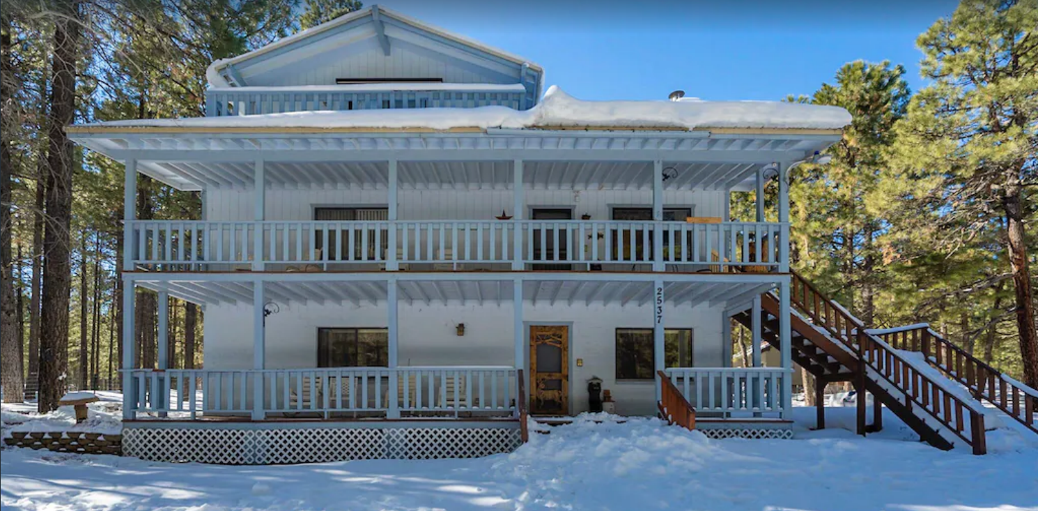 Cabin Front View - A front view of the cabing in the winter after a little snow. Our kids love to sled down the snow on the main stairs.