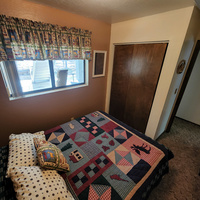 The "Deer" bedroom is fully themed with deer decor. It features a queen size bed, closet and dresser. It also has a window that looks out onto the back porch and back yard.