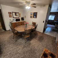 Another view of the dining room looking towards the back of the cabin. Here you can see some of the amenities incuding the Keurig coffee maker and microwave. The cabinets in the dining area are full of games, DVD's and many other fun items.